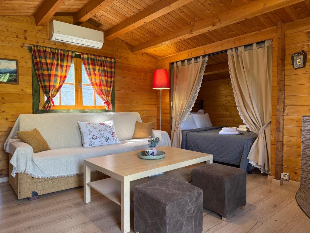 a living room with a couch and a table at Wild Life Chalets in Rafína