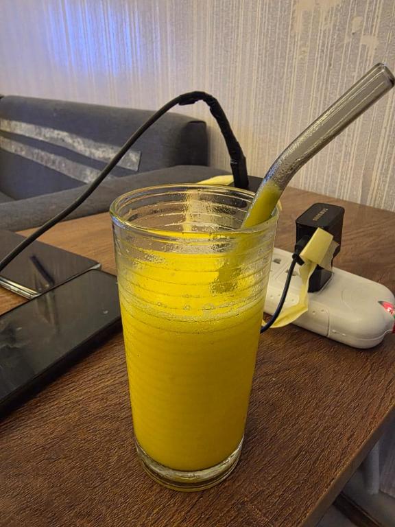 a glass of orange juice sitting on a table at Jor in Amman