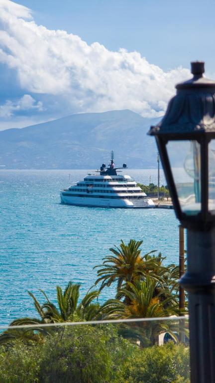 a cruise ship in the water with a yacht at Diamond Prestige Hotel in Sarandë