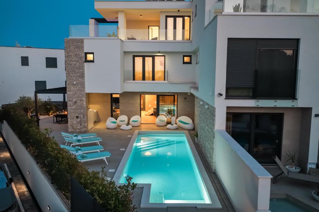 an aerial view of a house with a swimming pool at Villa Fortunal in Murter