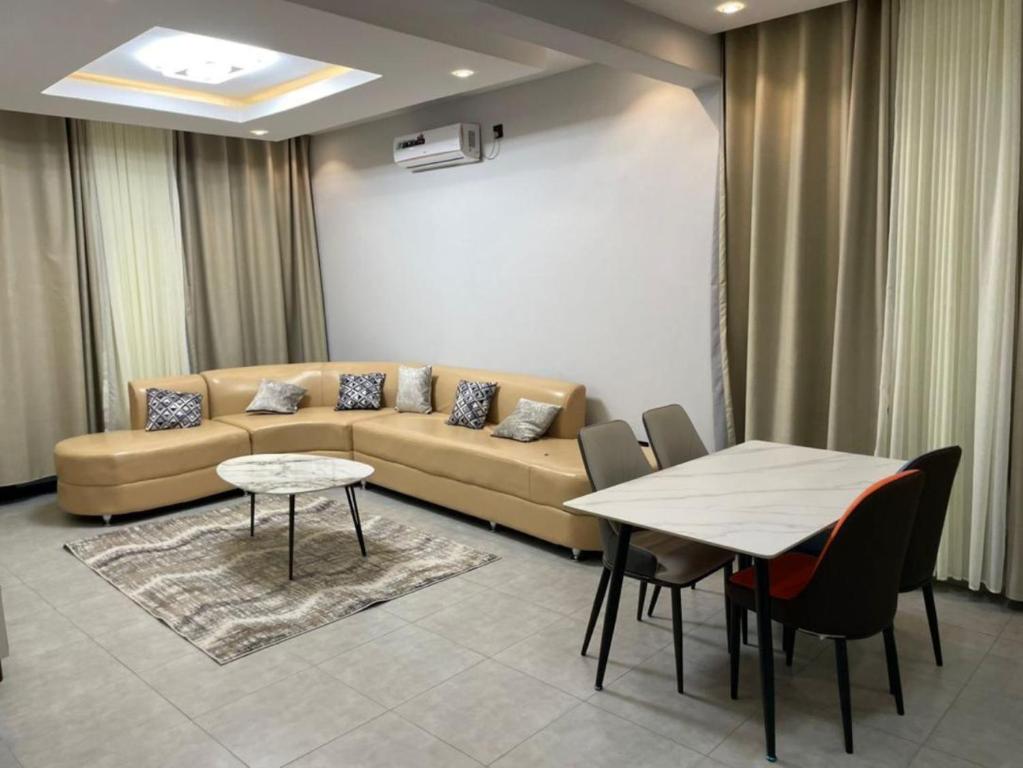 a living room with a couch and a table at Appartements Rebero Hills in Kigali