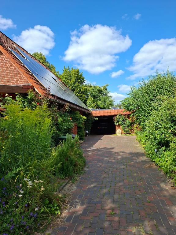 a brick walkway leading to a building with a roof at Gästeappartement Appricot in Adendorf