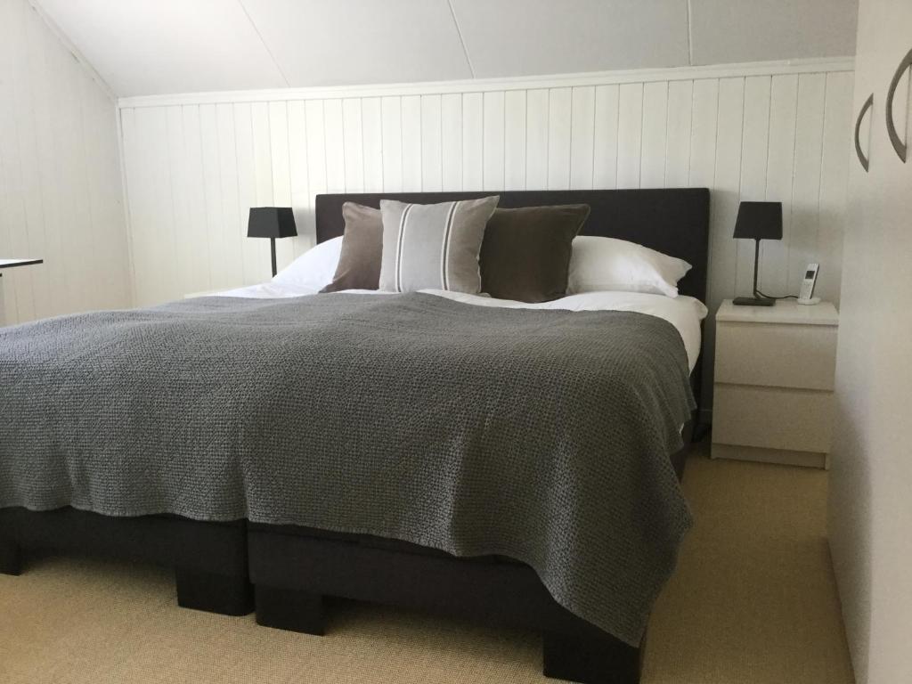 a bedroom with a large bed with pillows at Charming House In Herrliberg in Herrliberg