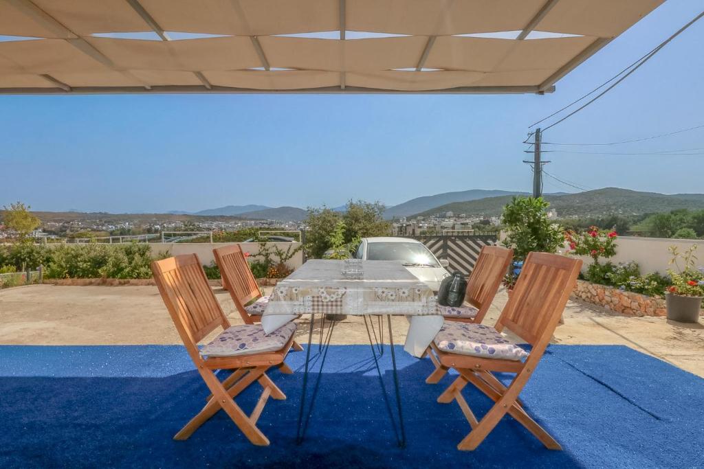 a table and chairs on a patio with a view at Vila Bliss in Ksamil