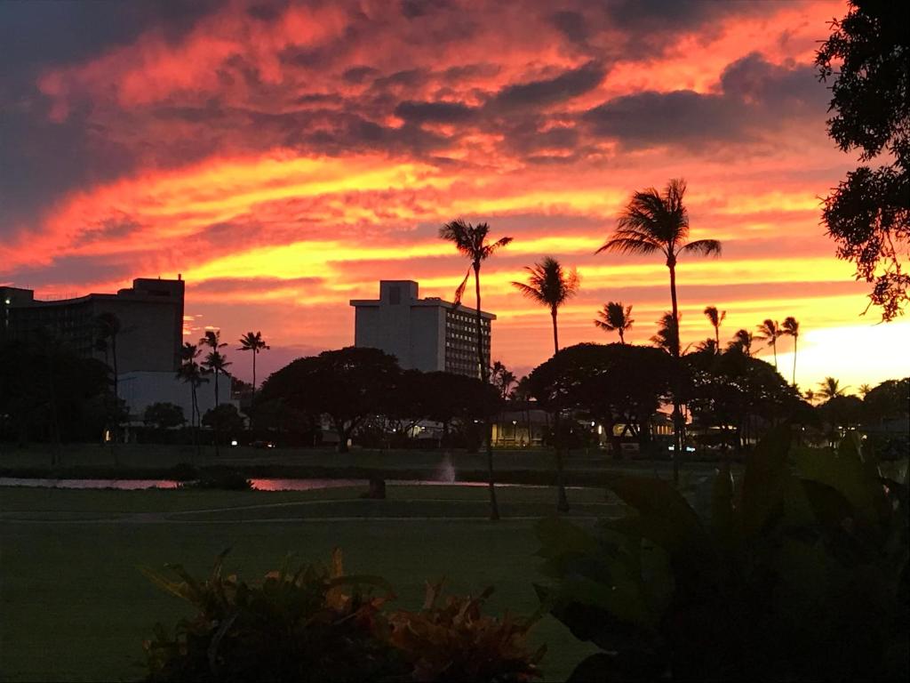 a sunset over a golf course with palm trees at Kaanapali Royal C102 in Lahaina