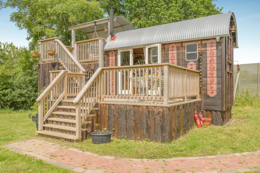 a large wooden house with a large deck at 1 Bed in Elsing oc-d44228 in Elsing