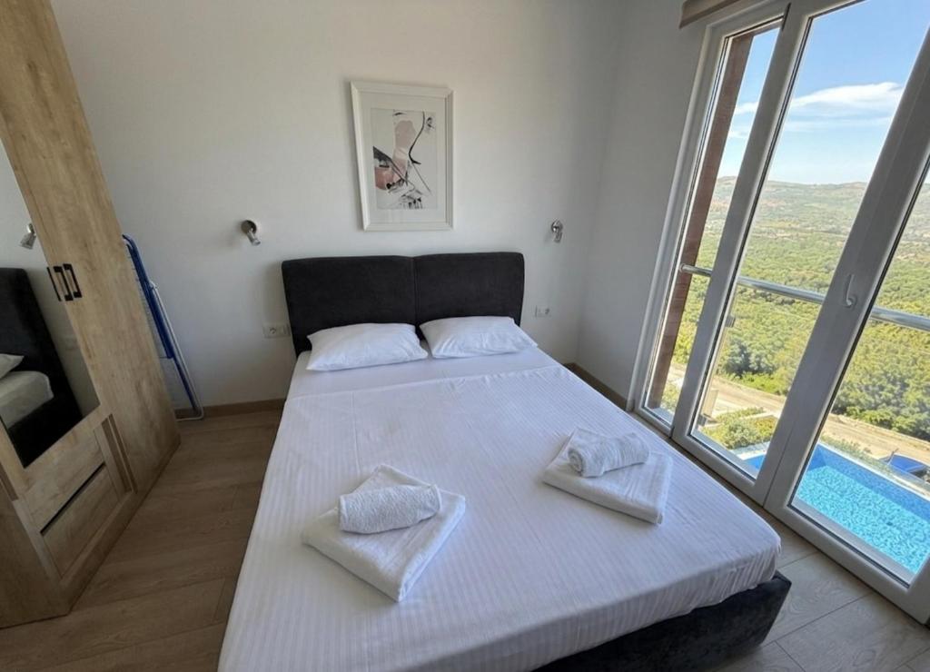 a bedroom with a bed with two towels on it at Cosy Adriatic Studio in Kotor