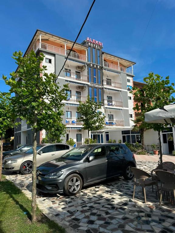 two cars parked in front of a building at Hotel Aleksi Velipojë in Velipojë