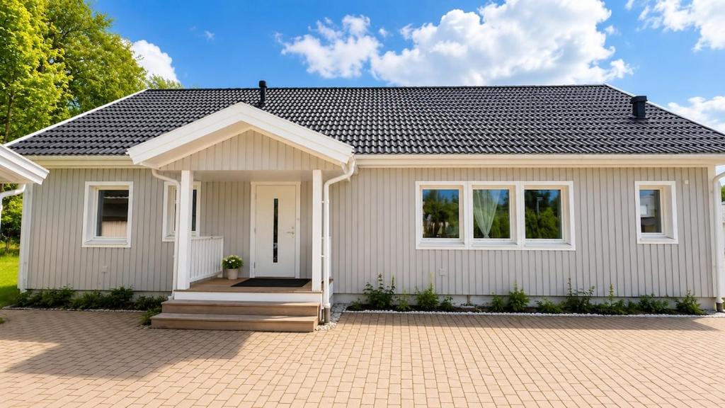 a small white house with a porch at Villa Kaxberg in Södertälje