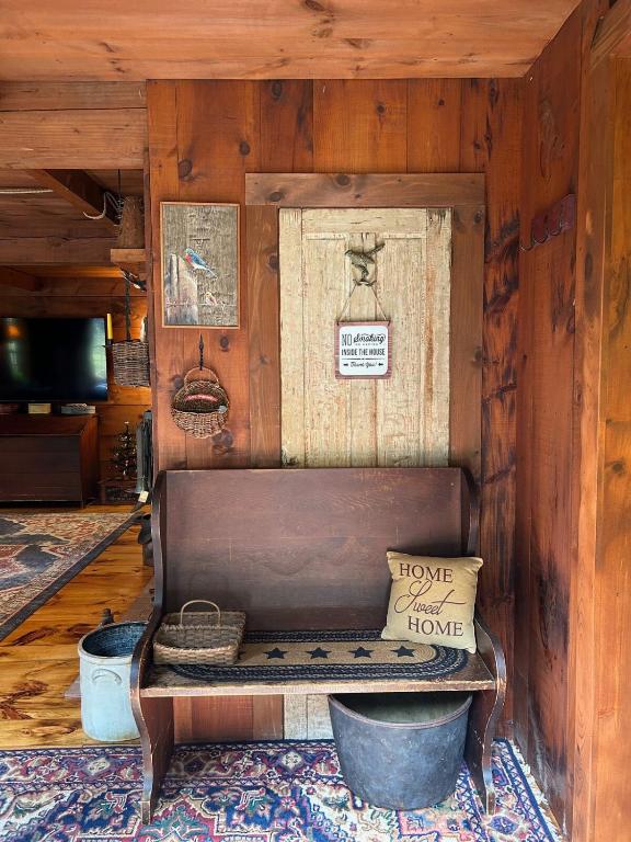 a wooden room with a bench in a room at Old Deerfield Treasure! in Deerfield