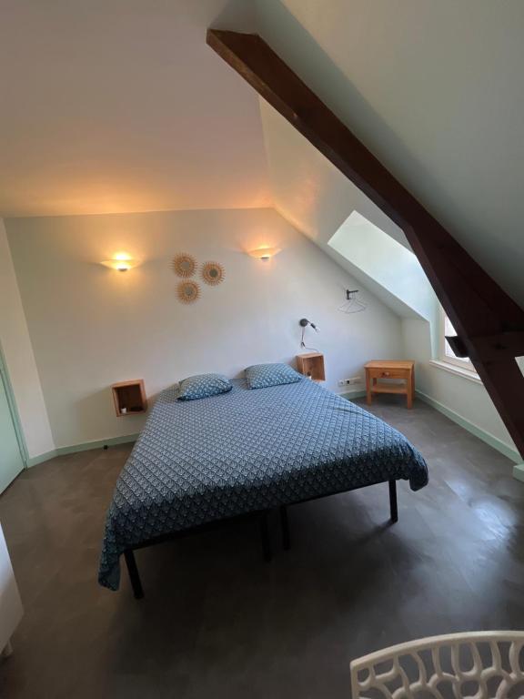 a bedroom with a bed in a attic at studio 3- les moulins in Cherbourg en Cotentin