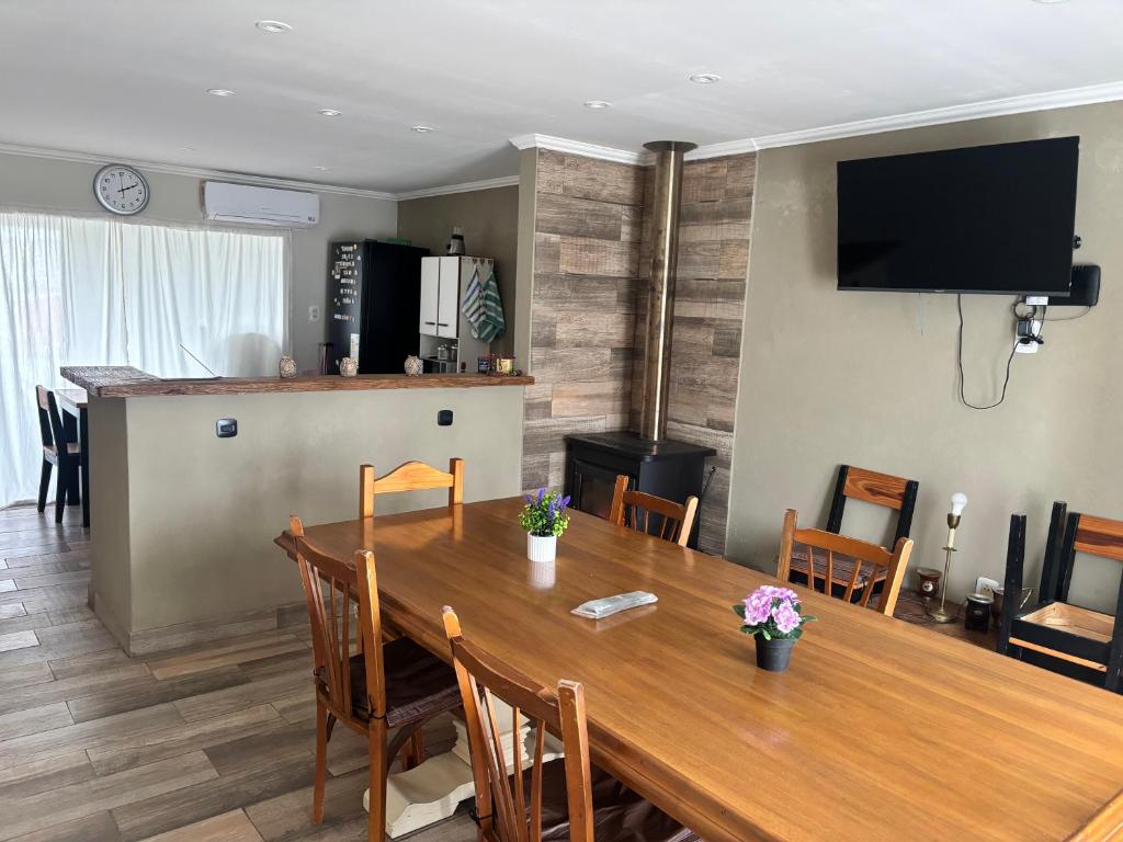 a dining room with a large wooden table with chairs at Alumine in Coronel Suárez
