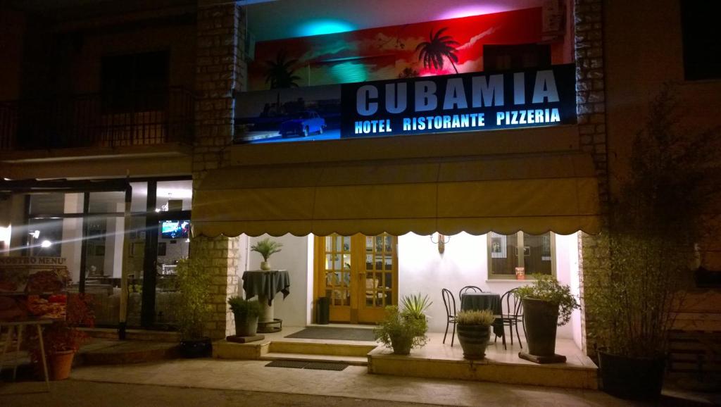 a building with a sign on the front of it at night at Hotel Cubamia in Romano D'Ezzelino