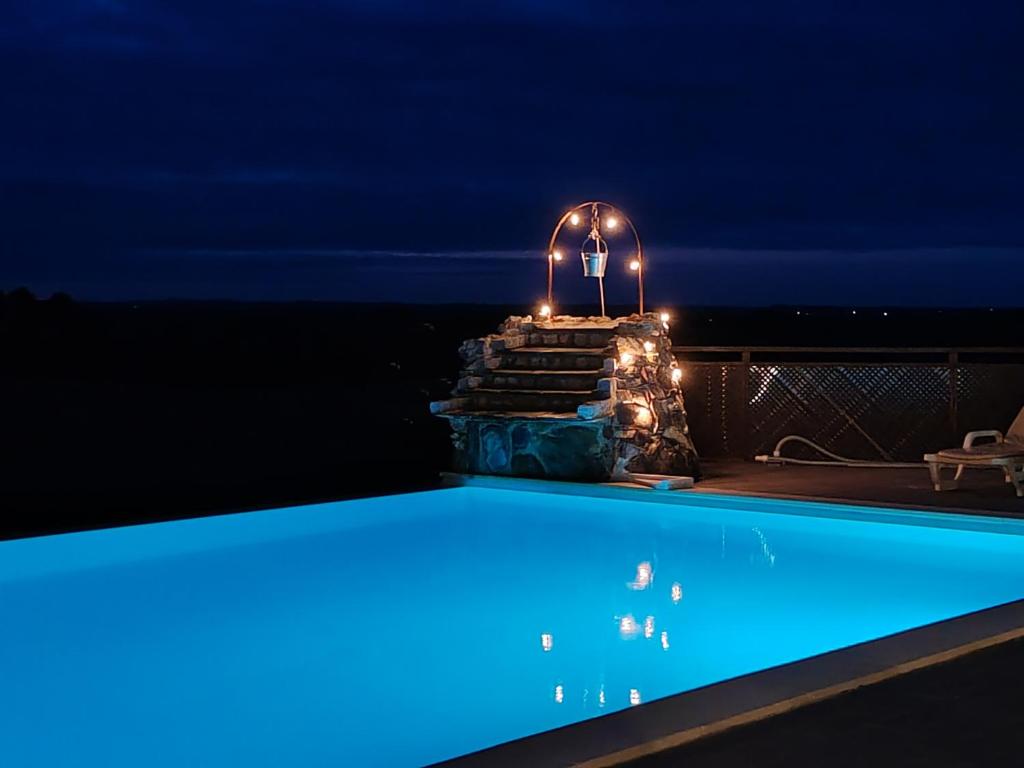 a swimming pool lit up at night at Herdade Monte Novo Do Pocinho in Cercal