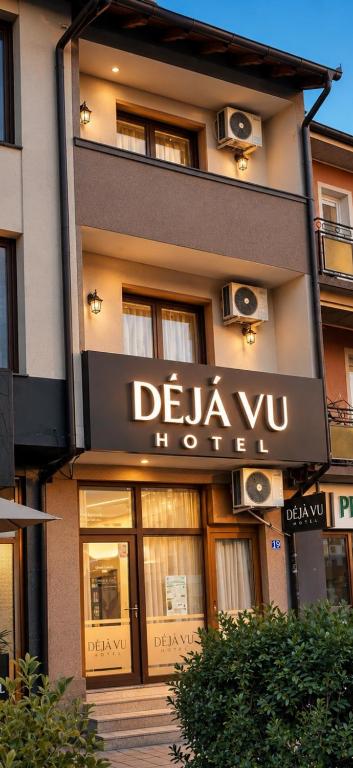 a building with a sign for a delaney hotel at DejaVu Hotel in Prizren