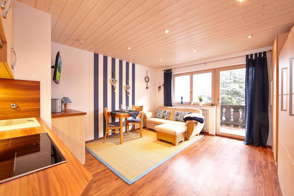 a living room with a couch and a table at Frickenblick Lounge & Sauna in Farchant