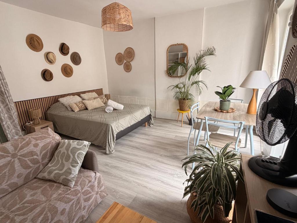 a living room with a bed and a couch at Grand Studio Centre Fontainebleau INSEAD - Cocon Deluxe in Fontainebleau