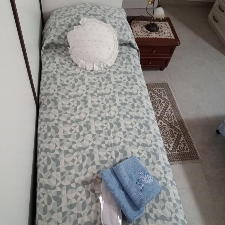 a bed with a pillow and a towel on it at Casa Evelina in Villanovotulo