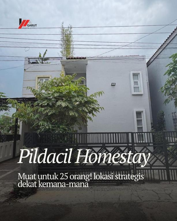 a white house with a fence in front of it at Pildacil in Garut