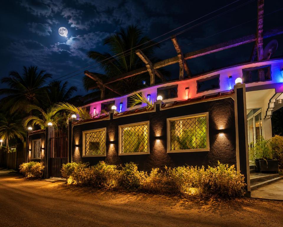 a building at night with the moon in the background at Royal Beach Hotel in Trincomalee