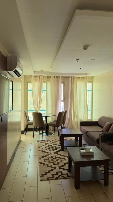a living room with a couch and a table at فيولورين سويتس in Al Baha