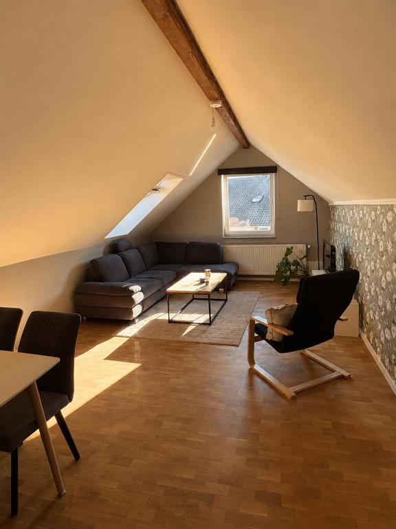 a living room with a couch and a table at Moderne Dachgeschosswohnung in Kirchlengern