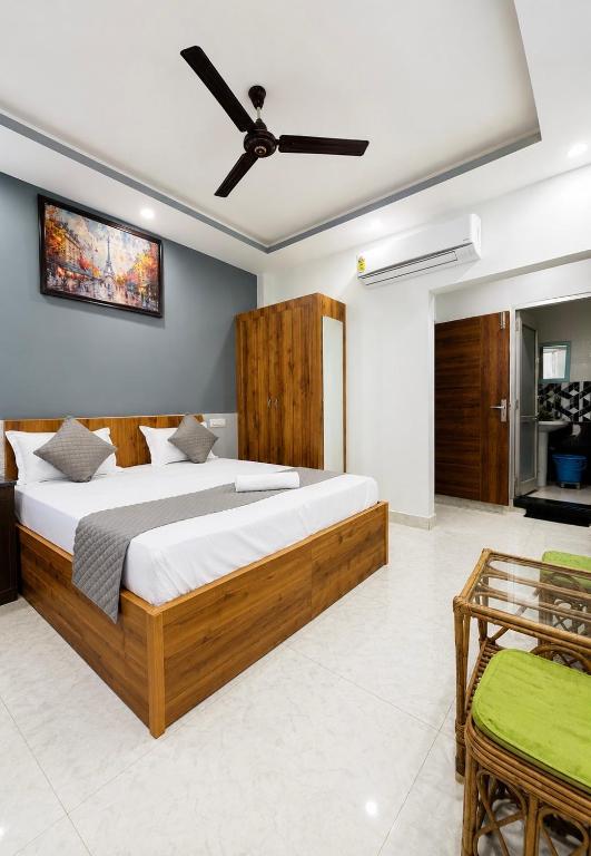 a bedroom with a large bed with a ceiling fan at Parvati home stay near by ramjhula,luxmanjhula in Rishīkesh