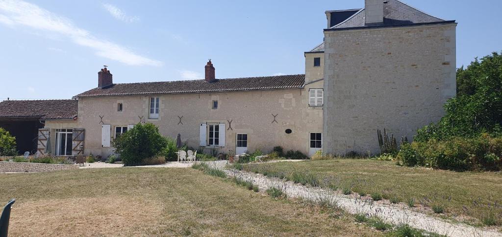 a large building with a tower on top of it at Les Fleurs de La Brise in Nueil-sous-Faye