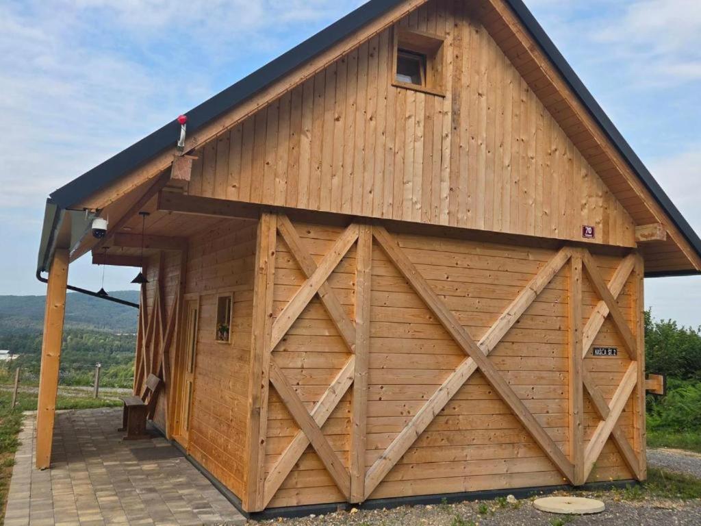 a large wooden barn with a large door at Ranč na hribu in Trebnje