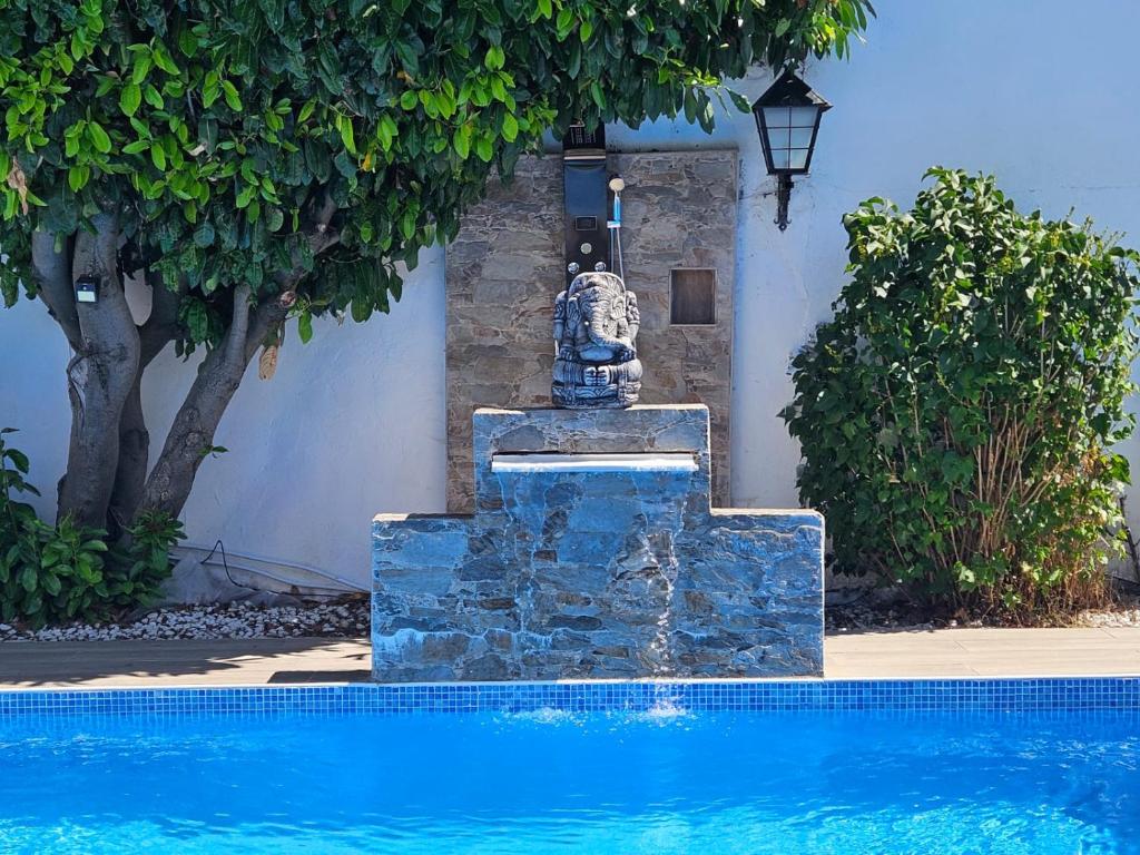 a fountain in the middle of a swimming pool at Lila Natur León1 Apartment 4 Pers in Villafañé