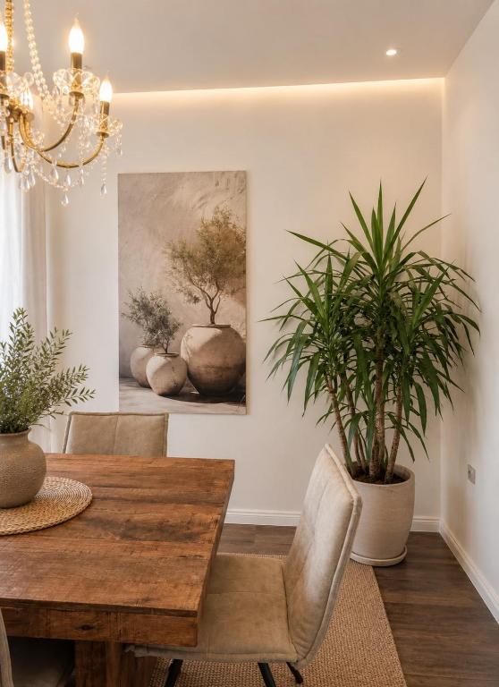 a dining room with a wooden table and plants at Villa Olivia in Banjole