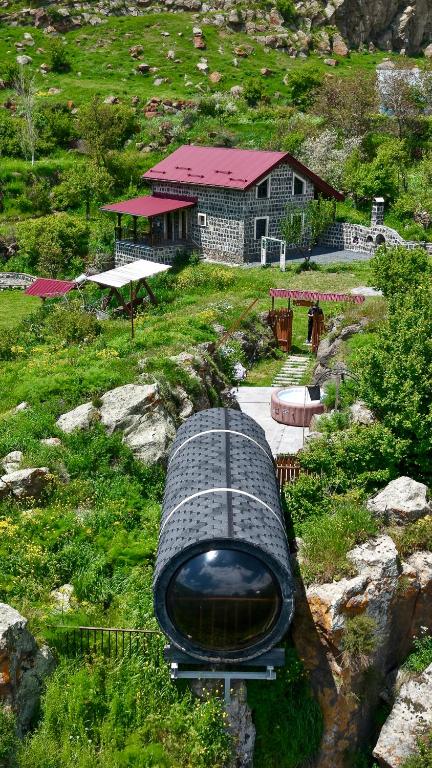 a train in front of a building on a hill at River Home Villa in Kʼaghsi