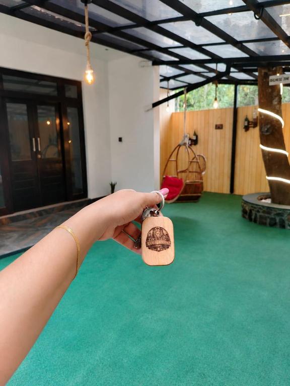 a person holding a bottle in their hand at Leo's Cozy Cabin in Ella