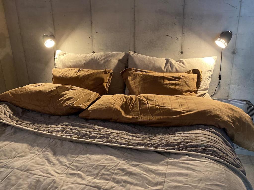 a large bed with two pillows on it at Leilighet ved fjorden in Årak