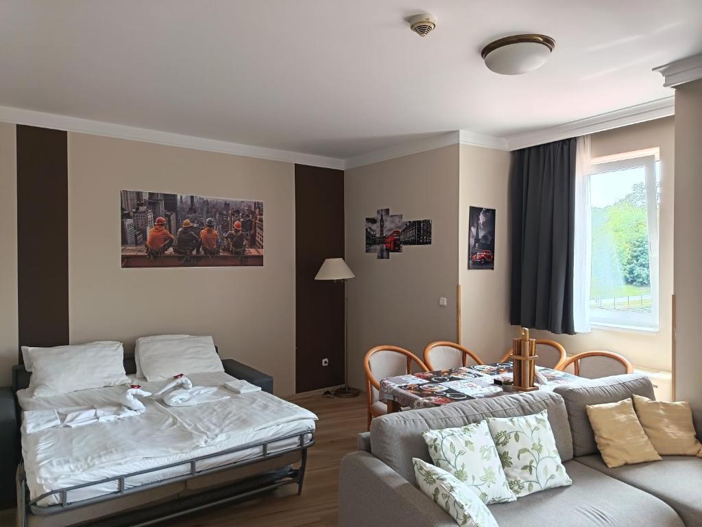 a living room with a couch and a table at alma713 apartman in Zalakaros