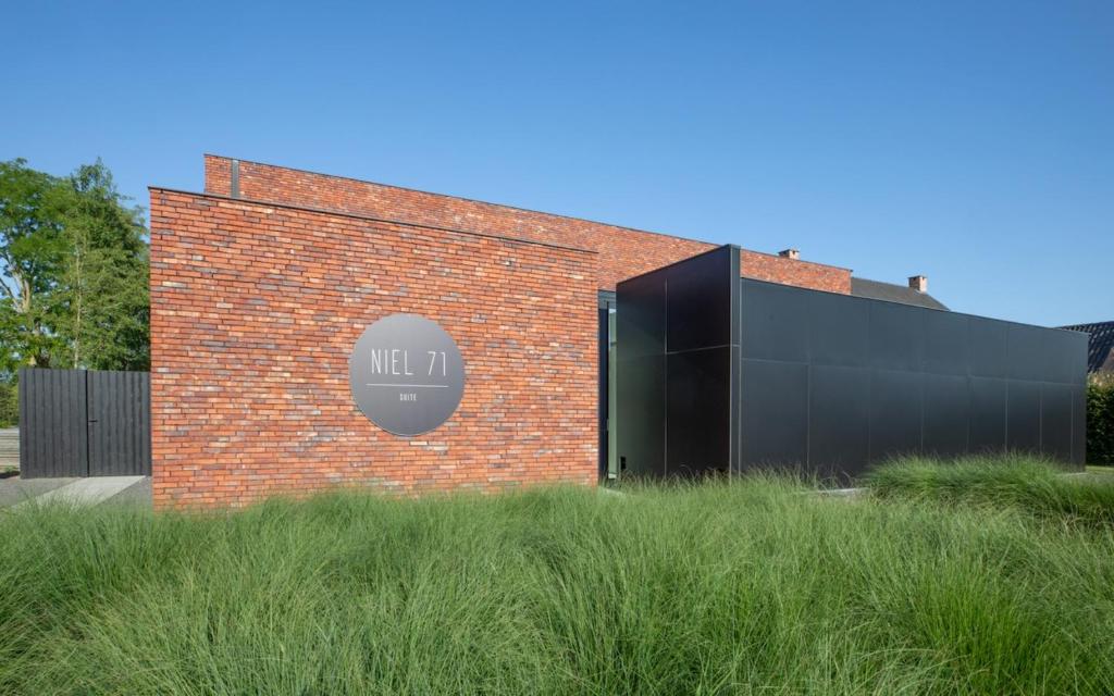 a brick building with a sign on it at NIEL71 Suite in Kerniel