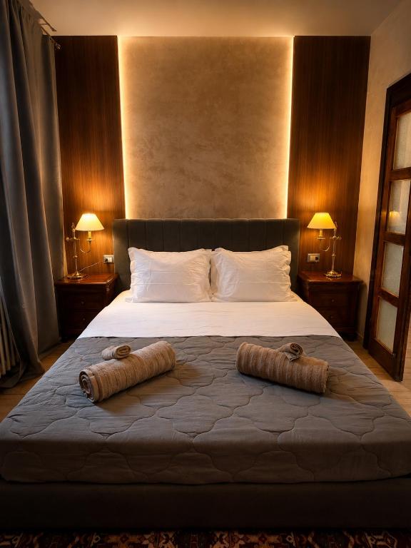 a bedroom with a large bed with two pillows on it at Siham lake home in Verceia