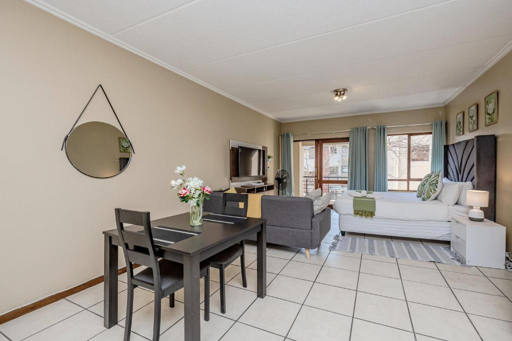 a living room with a table and a couch at Grace Haven in Sandton
