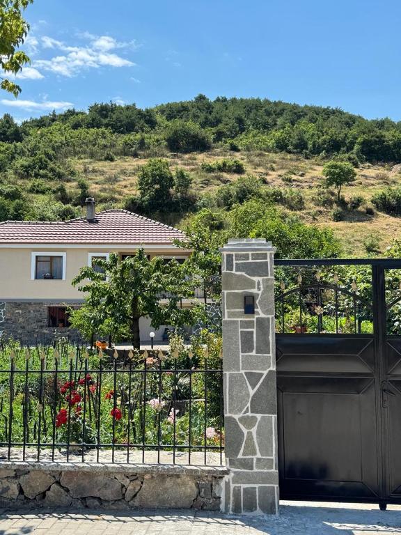 a gate in front of a house with flowers at The Grandparent's House in Piskupat