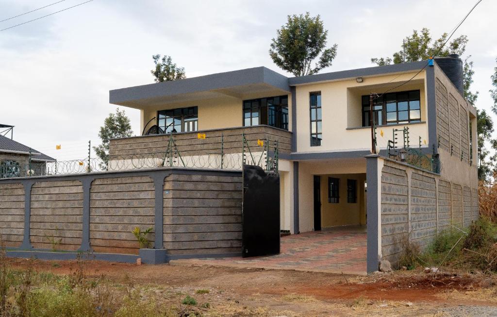 a house with a fence in front of it at Godly Homes 5km frm Weiteithie! 4BR mdrn home in Ruiru