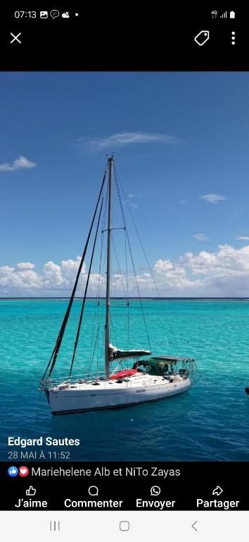 a boat sitting in the middle of the ocean at Voyager autrement in Moorea