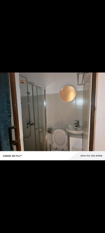 a small bathroom with a toilet and a shower at Lions adventure in Narok