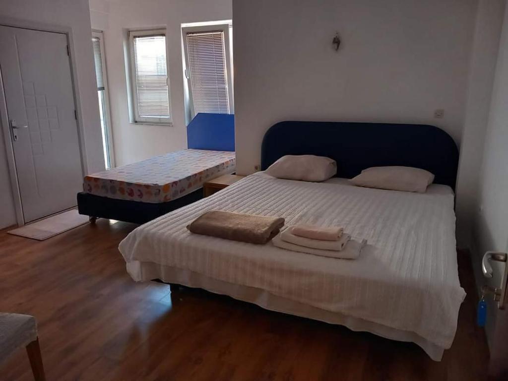 a bedroom with a bed with two towels on it at Charshija in Struga