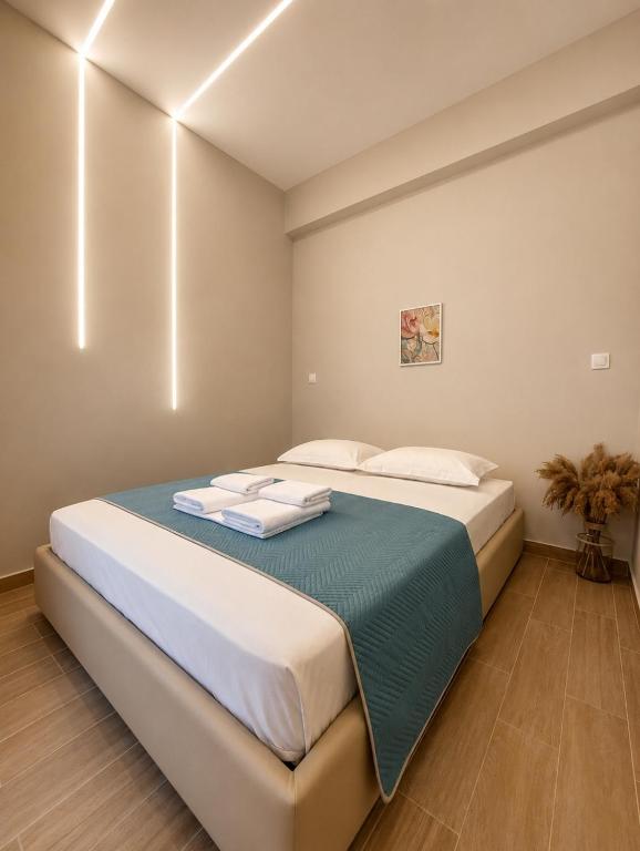 a bedroom with a large bed with towels on it at Galazio suites 3 Seaside in Salamina