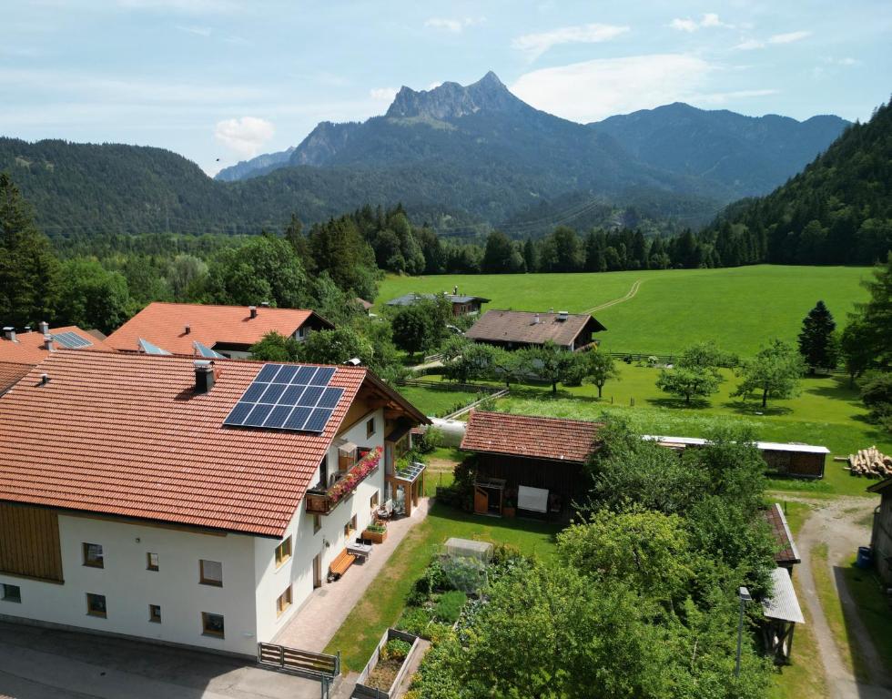 a house with solar panels on the roof at Haus Wörle- Ferienwohnung "Hahle" in Musau