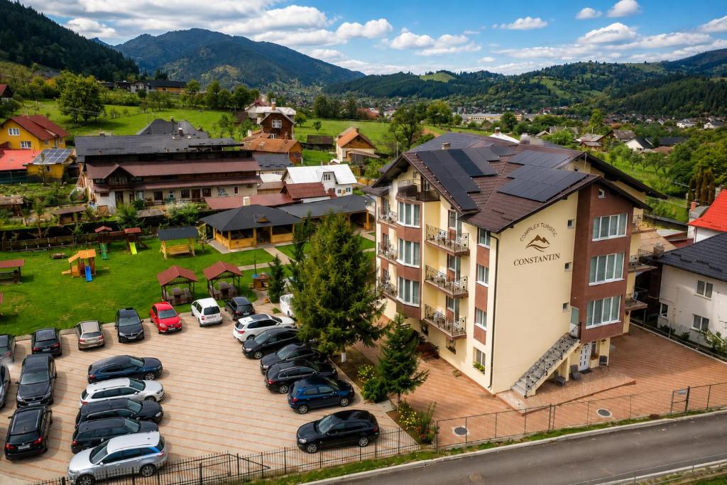 an aerial view of a hotel with cars parked in a parking lot at Complex Turistic Constantin Bucovina in Câmpulung Moldovenesc