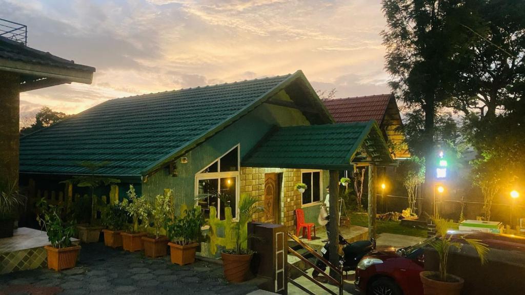a small house with a green roof at Coorg Annu Stay in Madikeri