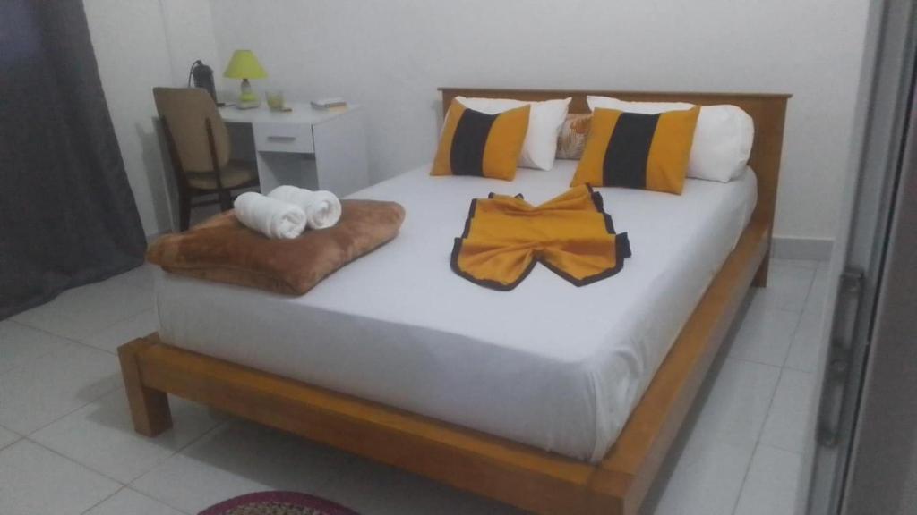 a bedroom with a bed with towels and a table at villa Moissuli par chambre in Mtsamboro