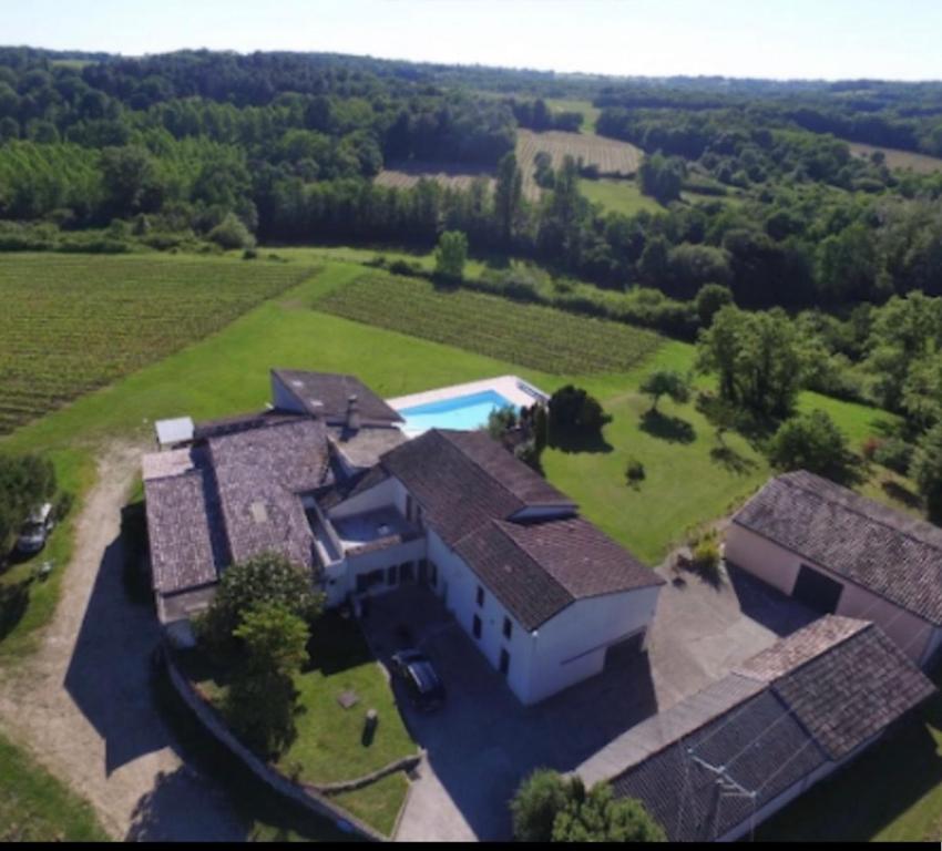 an aerial view of a large house with a pool at La rose Poncet in Gardegan-et-Tourtirac