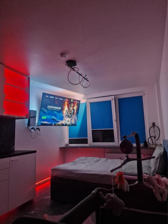 a bedroom with a bed and a flat screen tv at Moon Love in Pakopi